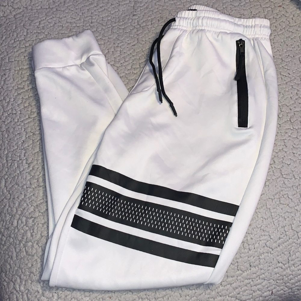 White joggers zip pockets, black stripe design